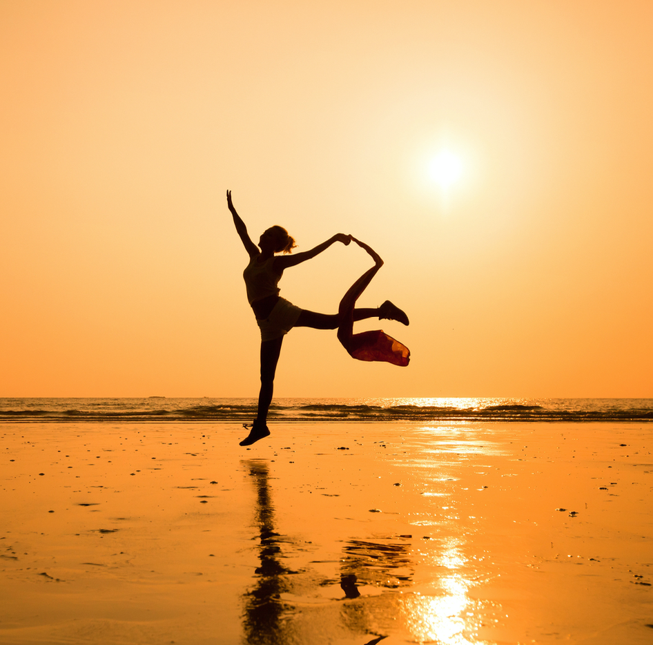 A dancer silhouetted at sunset